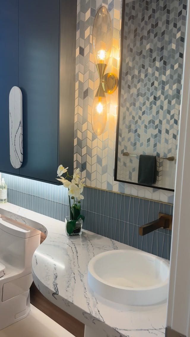 14 Bathroom Small Space Storage Ideas That Actually Fit 13 White marble bathroom countertop with a curved edge and a white vessel sink.