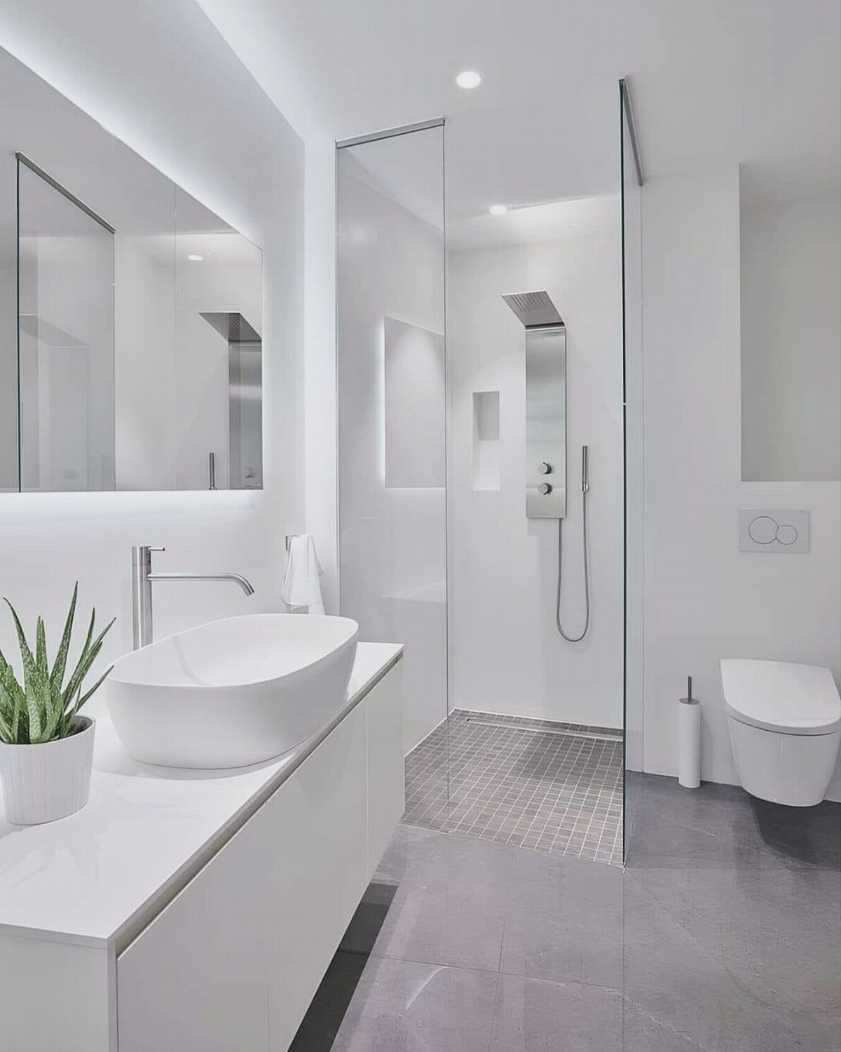14 Bathroom Small Space Storage Ideas That Actually Fit 14 Modern white bathroom with a vessel sink, large mirror, glass shower, and white toilet.