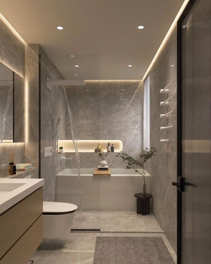 14 Bathroom Small Space Storage Ideas That Actually Fit 10 Modern grey marble bathroom featuring a built-in illuminated shower niche above a white bathtub.