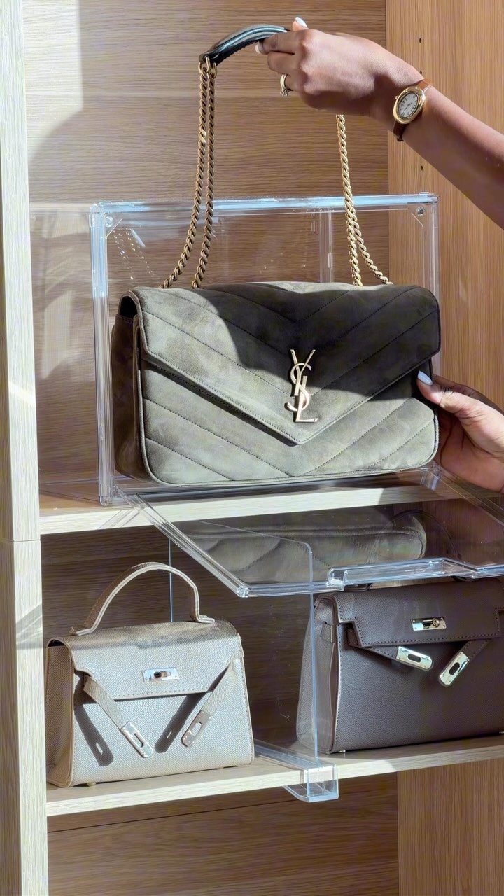 6 Closet Organization for Dresses Ideas That Save Space and Time 1 Hands reaching for designer handbags displayed on clear acrylic shelves in a wooden closet.