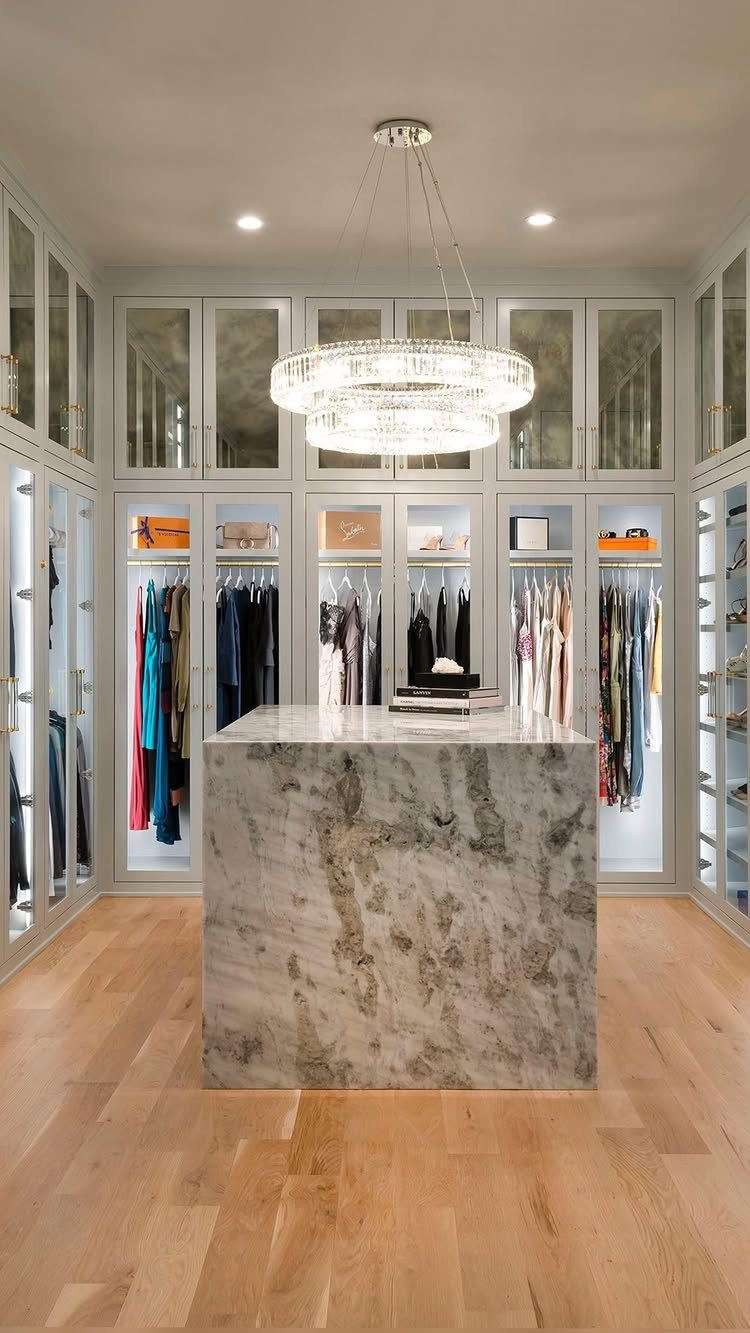 6 Closet Organization for Dresses Ideas That Save Space and Time 6 A luxury walk-in closet with organized dresses hanging in illuminated white glass-front cabinets.