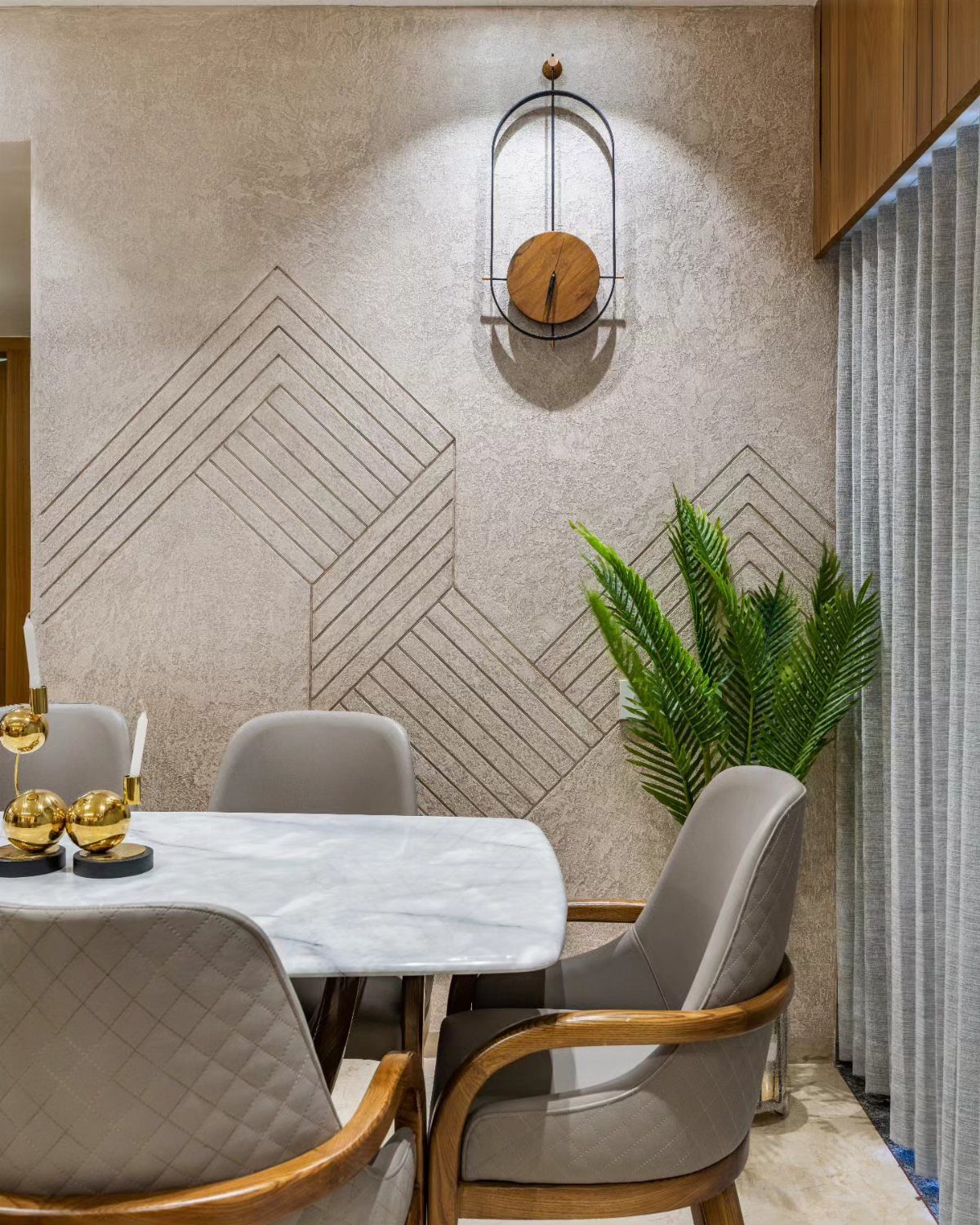 Dining room with a textured plaster accent wall featuring geometric black line patterns and marble table.