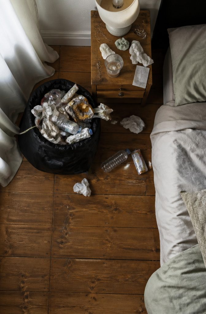 A trash bag positioned in a corner, ready for waste collection.