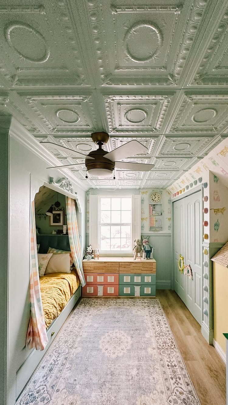 Mint green embossed tin ceiling with a ceiling fan in a child's bedroom.