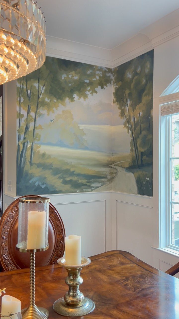 A landscape mural painted on a corner wall depicting trees and a winding path.