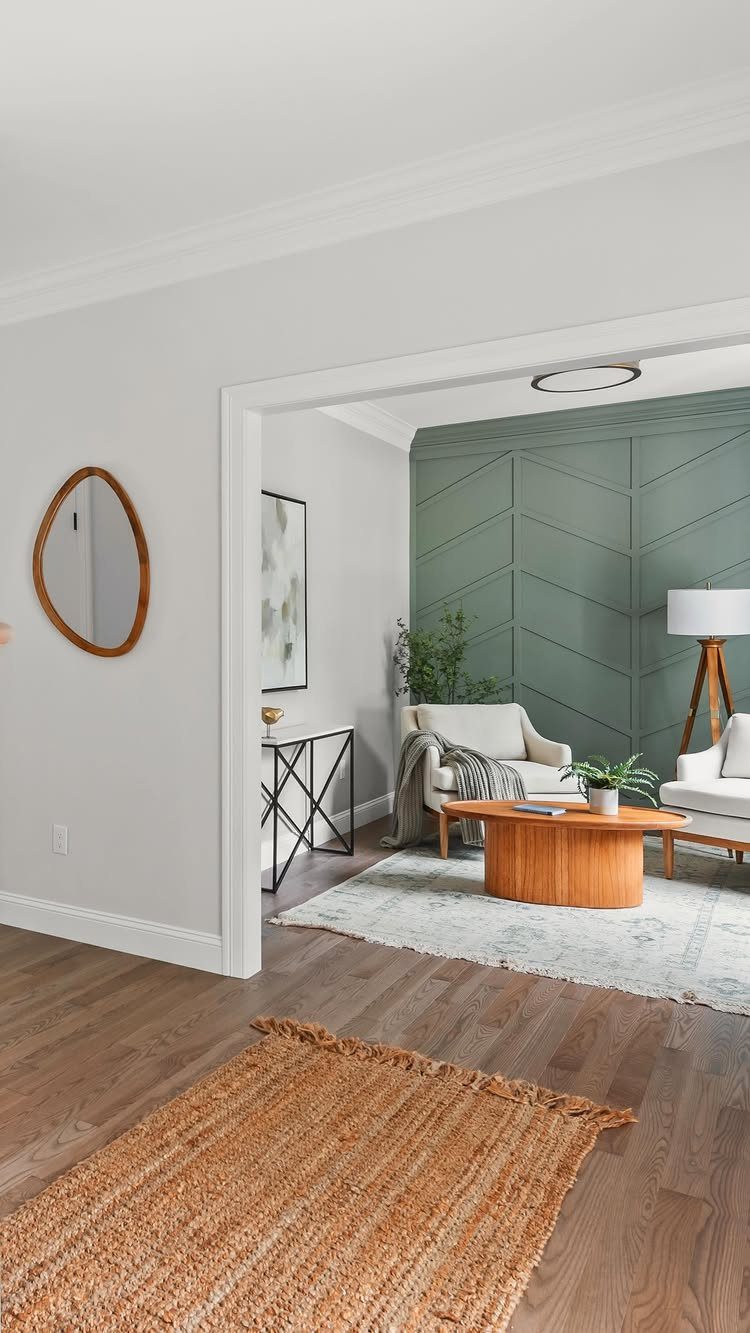 9 Interior Accent Wall Ideas with Photos 2 A sage green living room wall featuring a large wooden chevron pattern design.