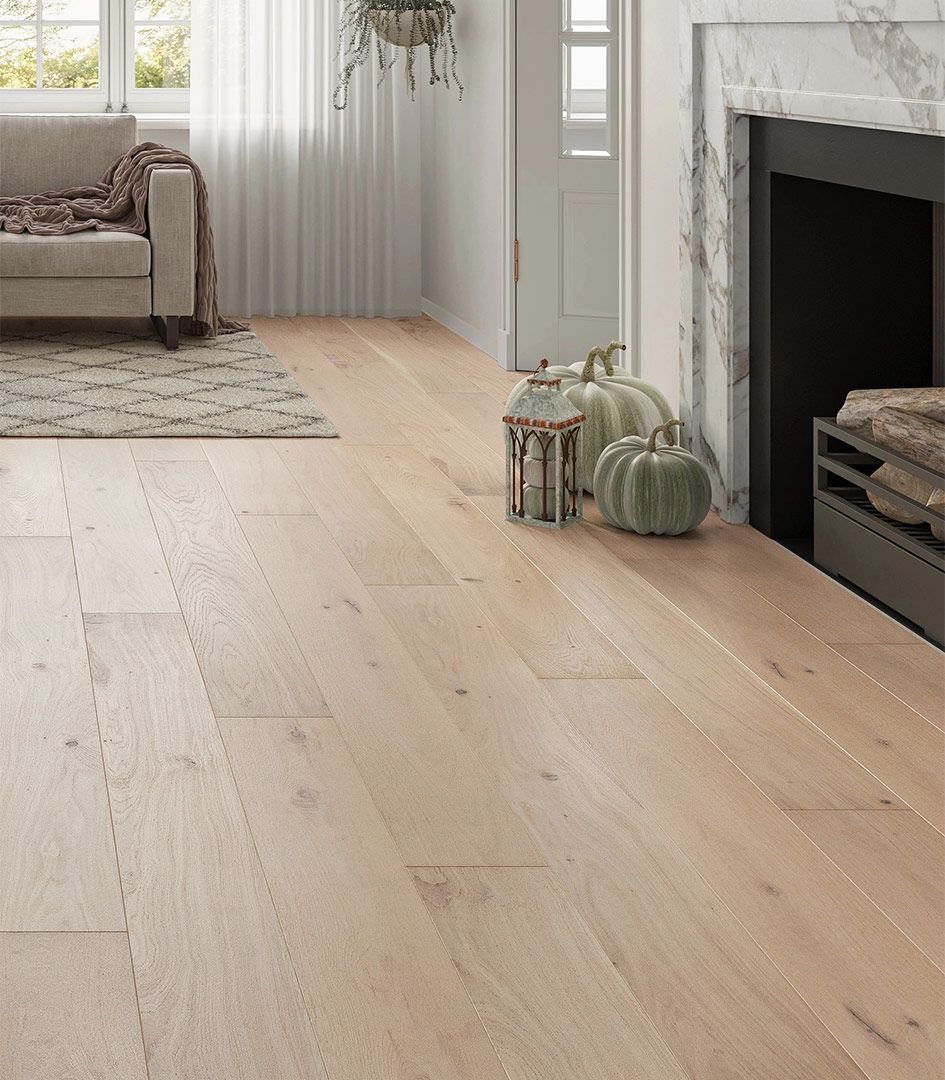 Light oak wood-look flooring in a bright living room with a sofa and fireplace.