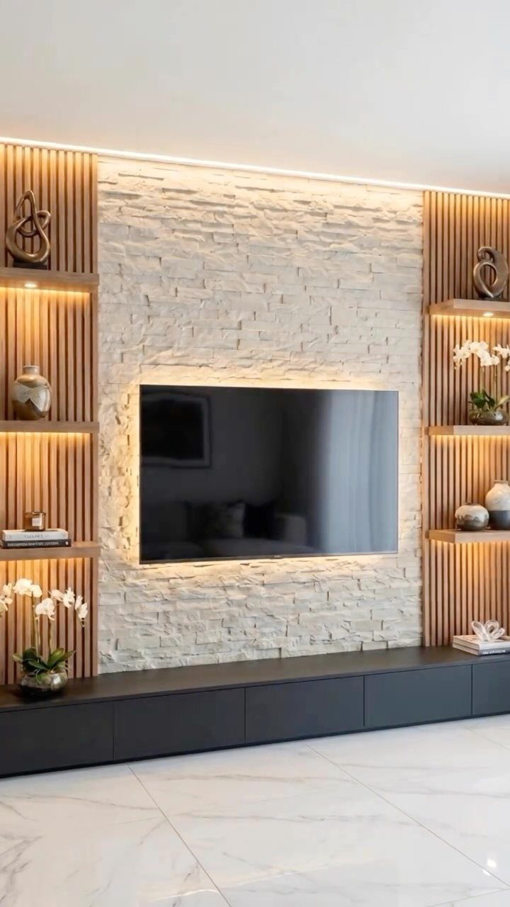 A modern living room wall with stone texture, wood slats, and integrated LED lighting.