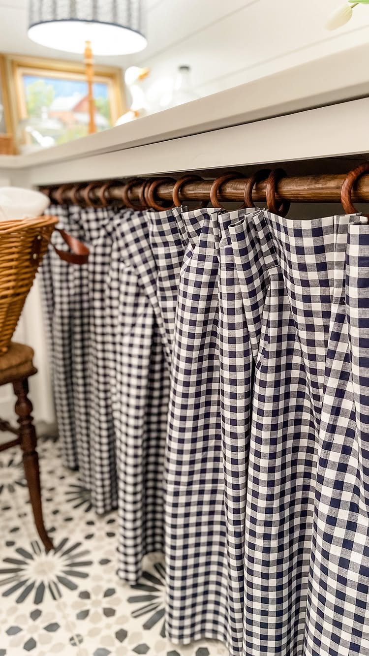 10 Small Laundry Closet Ideas That Actually Fit in a Hallway 4 Blue and white gingham curtains hanging from a wooden rod in a laundry room.