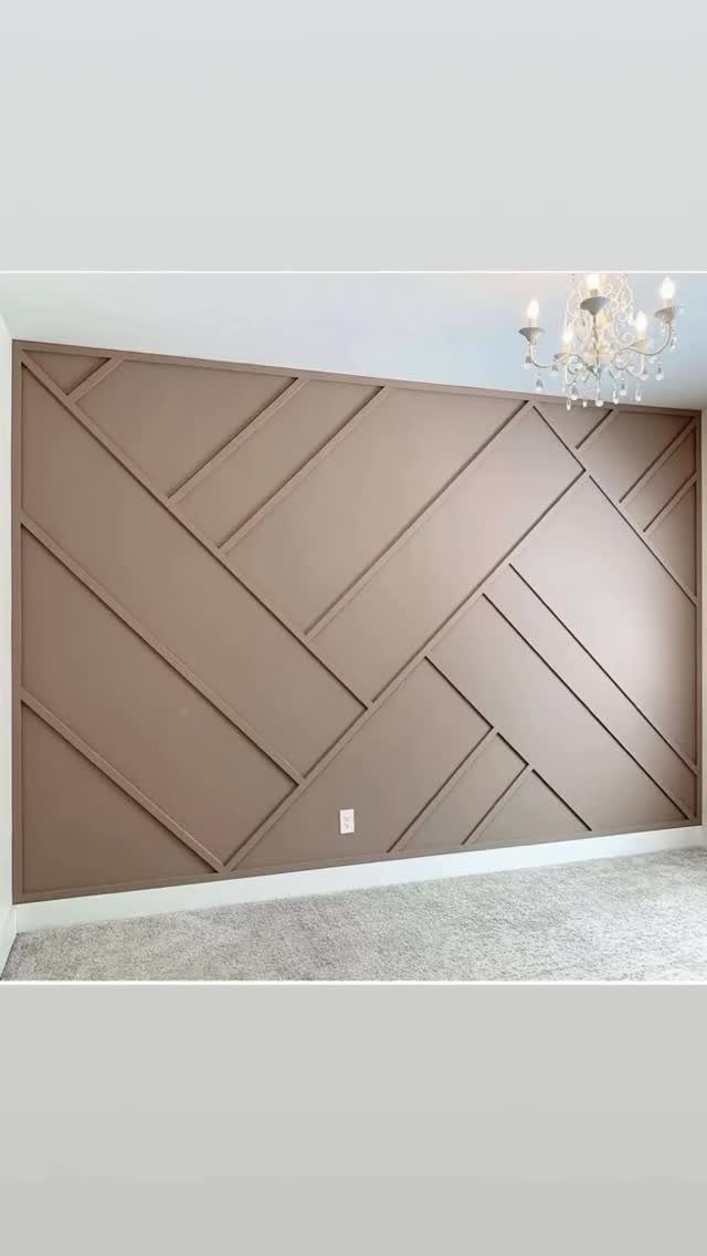 Geometric taupe wall paneling with intersecting diagonal and vertical wooden slats in a bedroom.