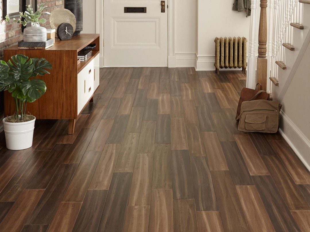 Wood plank flooring with high color variation in shades of brown in a hallway.